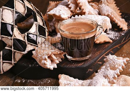 Carnival Food Typical, Mask And Aromatic Coffee On A Woody Background. Sfrappole Or Chiachiere Or An
