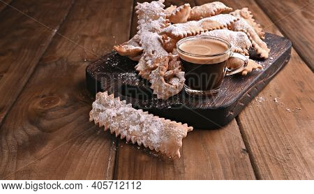 Carnival Food Typical And Aromatic Coffee On A Woody Background. Sfrappole Or Chiachiere Or Angel Wi