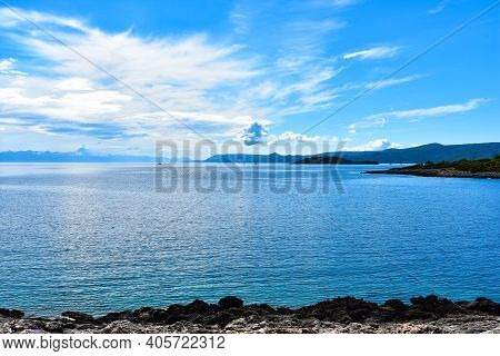 Beautiful Adriatic Sea In Croatia. Blue Calm Water, Cloudy Sky, Stony Coast, Nice