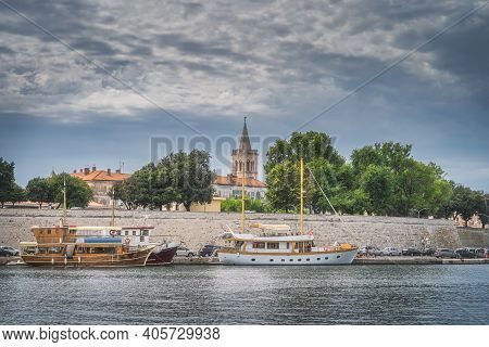Marina With Moored Sailboats In Zadar Bay. Fortification, Walled Old Town And Belltower Of Church Of