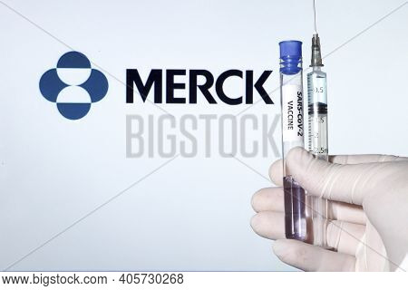 Madrid, Spain- January 7, 2020: Hand On White Surgery Glove Holding Syringe With Covid Vaccine. In T