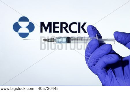 Madrid, Spain- January 7, 2020: Hand On Blue Surgery Glove Holding Syringe With Covid Vaccine. In Th
