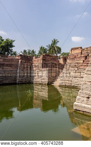Aihole, Karnataka, India - November 7, 2013: Weeds Grow In Greenish Water Of Chakra Gudi Tank With B