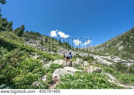 Hikers Clime The Way Up To Olpererhutte In Zillertal Alps In Austria Summer