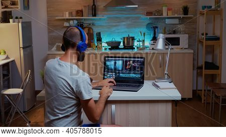Creative Filmmaker Editing Video Footage In Home Using Modern Technology. Man Content Creator In Hom