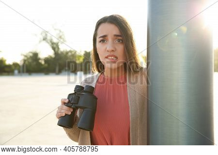 Jealous Woman With Binoculars Spying On Ex Boyfriend Outdoors