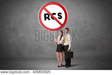 Young business person holdig traffic sign with RCS abbreviation, technology solution concept