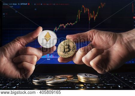 Business Men Holding Bitcoin And Ethereum Coin Whit Computer Trading Chart Background. Bitcoin And A