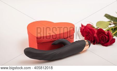 Black Dildo And Heart Shaped Box And Red Roses On A White Background. Valentines Day Gift.