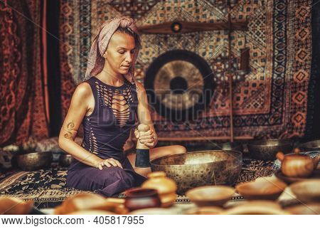 Spiritual Girl Immersed In Meditative Sounds Of Tibetian Bowl.