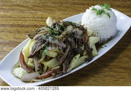 Peruvian Dish Called Lomo Saltado Made Of Tomato, Beef Meat And Onions Mixed With French Fries And S