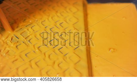 A Man Pours Yellow Paint Into A Tray. Yellow Paint Slowly Pours Into Black Paint Tray. Wall Painting