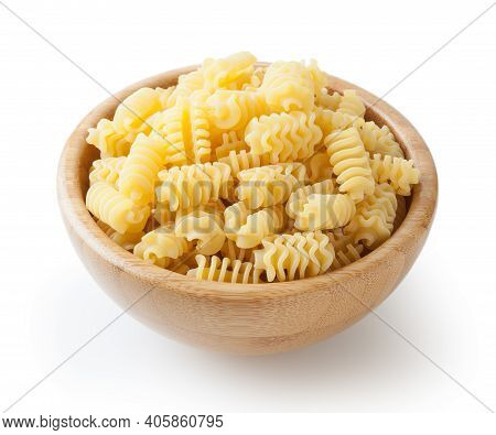 Uncooked Radiatori Pasta In Wooden Bowl Isolated On White Background With Clipping Path