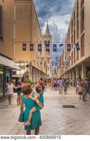 Zadar, Croatia, July 2019 Tourists Visiting Beautiful Streets Of The Old Town With Bell Tower Of St.