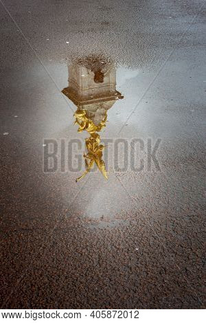 Reflecion In A Puddle Of The Gold Victory Angel Of The Vitoria Memorial, London, Uk