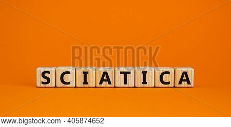 Sciatica Symbol. Wooden Cubes With Word 'sciatica'. Beautiful Orange Background. Medical And Sciatic