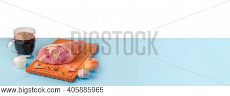 Raw Pork Knuckle, Dark Beer And Other Ingredients For Cooking Baked Pork Knuckle In Beer. Panoramic 