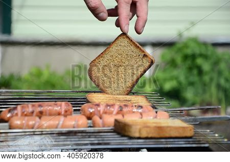 Sausages Are Cooked On A Grill On Coals . Bbq, Outdoor Barbecue .