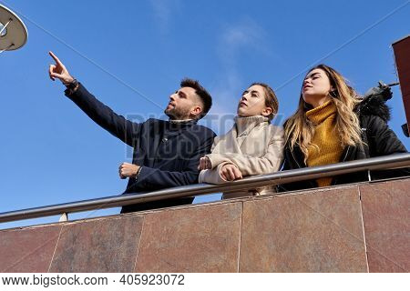 Three Happy Friends Talking Cordially. Leaning On A Railing. Friendship Concept
