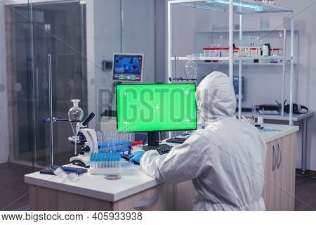 Medica Staff Using Computer With Green Mok Up In Scientific Laboratory. Team Of Microbiologists Doin