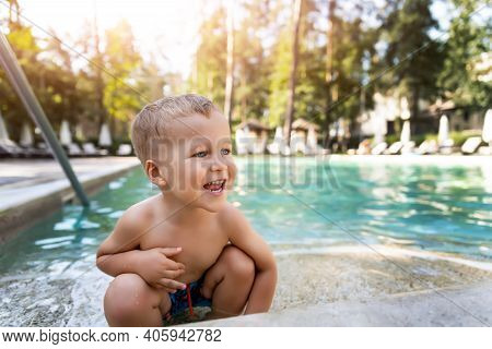 Little Cute Adorable Blond Playful Beautiful Caucasian Active Toodler Boy Enjoy Playing At Pool Edge