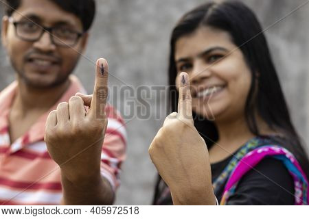 Indian Man And Woman Showing Ink-marked Fingers With Smiling Faces After Casting Vote
