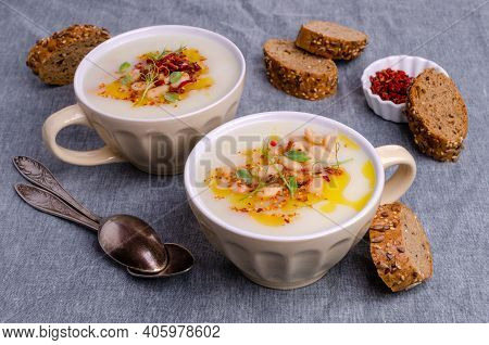 Vegetable Cream Soup With Beans And Spicy Oil In A Bowl On A Textile Background. Selective Focus.