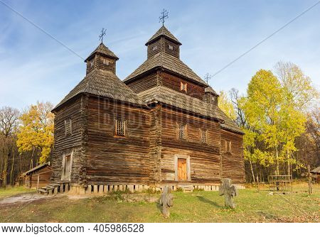 Old Wooden Church With Three Tent Shaped Domes, Built Of Pine Logs In The 18th Century, Autumn. Pyro