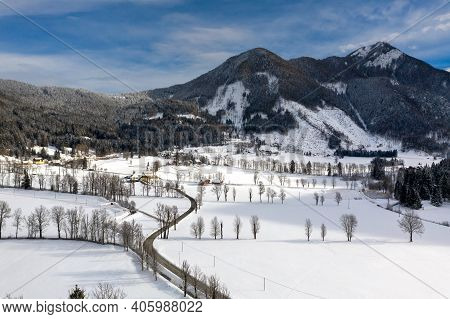 Aerial Winter Landscape With Mountain Village And Forest Covered In Snow. Zgornje Jezersko, Slovenia