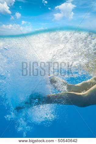 Young woman legs undewater in the sea