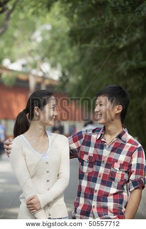 Young Chinese Couple Walking In Jing Shan Park