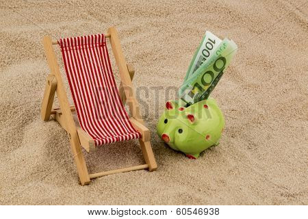 beach chair with euro currency on the sandy beach. symbolic photo for travel costs, vacation, holiday