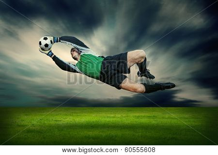 Football player with ball in action outdoors