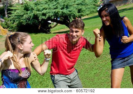 Young Man Holding Two Girls Fighting For Him