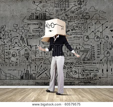 Businesswoman using mobile phone wearing carton box on head