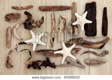 Starfish and driftwood abstract design over old oak background.