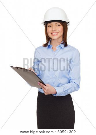 building, developing, consrtuction and architecture concept - smiling businesswoman in white helmet with clipboard