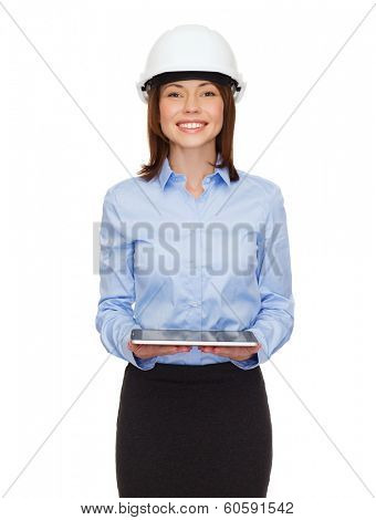 building, developing, consrtuction and architecture concept - friendly young businesswoman in white helmet with tablet pc computer