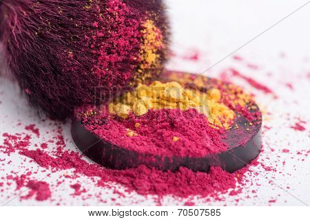 Close-up of  professional  make-up brush with crashed pink eye s