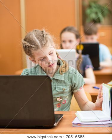 School Kids Using Notebook At Lesson