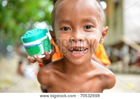one poor little child looking at camera curiously
