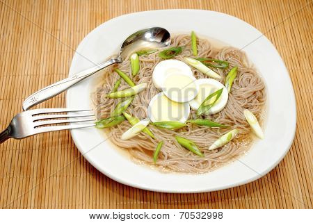 Oriental Egg And Noodle Soup Served In A Bowl