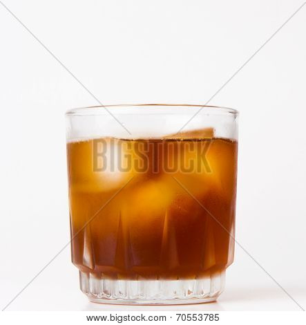 glass with ice tea full with ice cubes