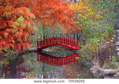Red bridge and water falls in Japanese garden