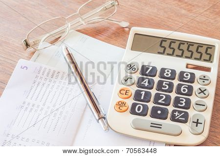 Calculator, Pen And Eyeglasses With Bank Account Passbook
