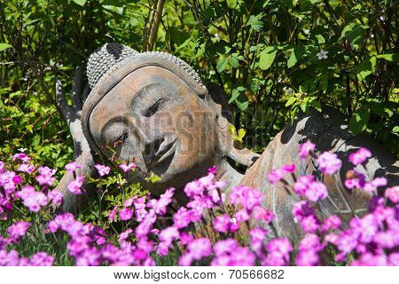 Garden Decoration With A Lying Buddha.