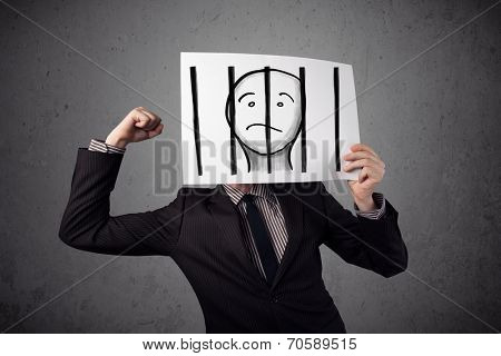 Businessman holding a paper with a prisoner in jail behind the bars on it in front of his head