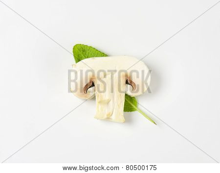 slice of champignon mushroom with leaf of sage