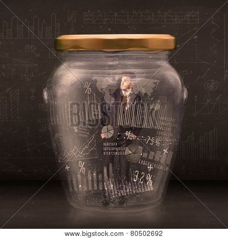 Businessman traped in jar with graph chart symbols concept on background