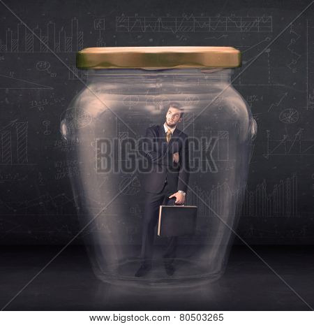 Business man closed into a glass jar concept on background